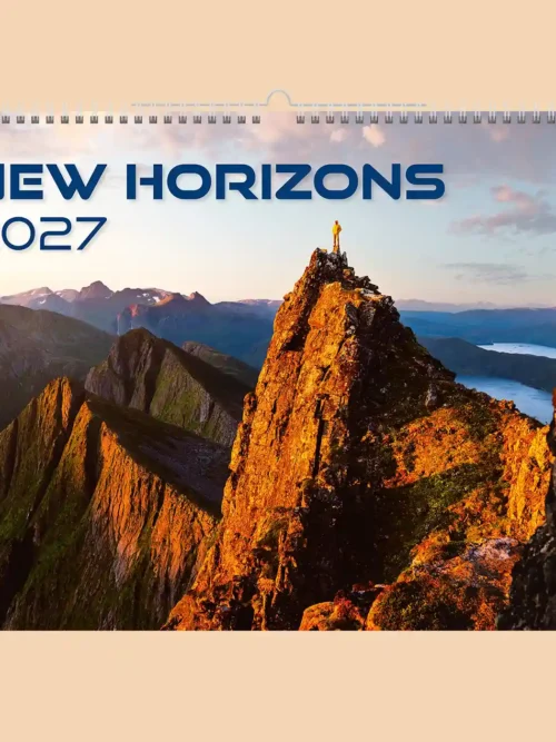 New Horizons 2027 wall calendar A3+, front cover: hiker on a rocky mountain peak at sunrise